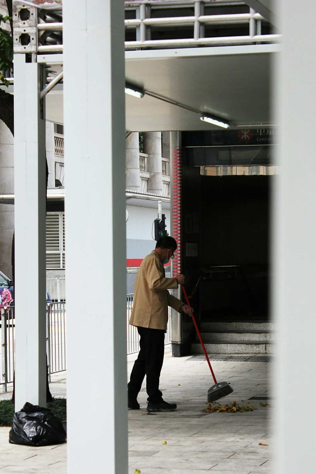 services-01 A person wearing protective equipment cleaning a kitchen appliance to maintain hygiene.